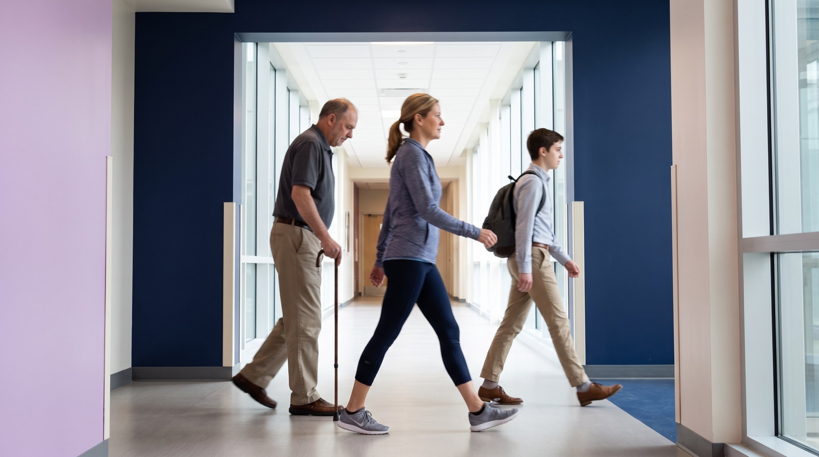 Clinician observing a patient's walking pattern during a gait assessment